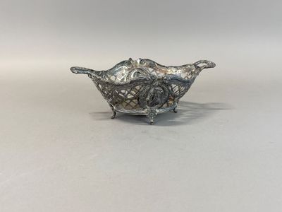 a close up of a silver bowl on a white surface