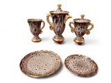 three pieces of pottery that are sitting on a table