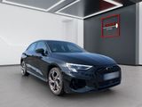 a black audi car parked in a garage with a red sign above it