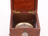 an old wooden box with a compass on top of it