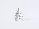 a close up of a silver ring on a white background
