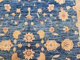 a blue and beige rug with a floral design on it