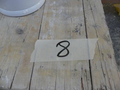a piece of paper on a wooden table with a number on it