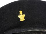 a black hat with a gold emblem on it
