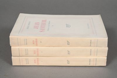 three books are stacked on top of each other on a table