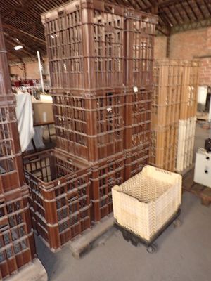 many crates stacked on top of each other in a warehouse