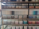 many cans of paint on the shelves in the store