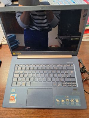a laptop computer sitting on a table with a cup of coffee