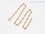 a close up of a gold chain with a clasp on it