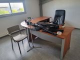 a chair and a desk in a room with a window