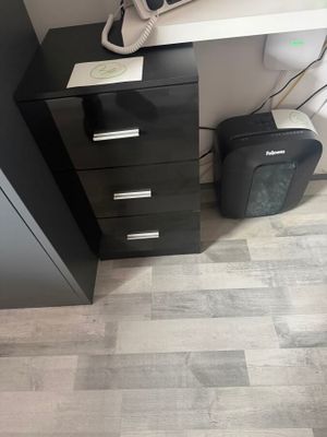a black cabinet with a phone on top of it