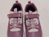 purple and white toddler ' s shoes on a white surface