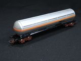 a silver and orange train car sitting on a black surface