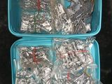 two plastic containers filled with silver and silver wires