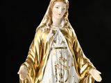 an image of a statue of a woman in a gold robe