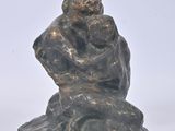 statue of a man and woman sitting on a rock