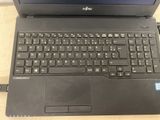 an open laptop computer sitting on top of a wooden table