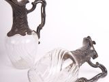 two glass vases with a horse on them on a white surface
