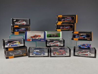 a collection of die - cast cars in display cases on a table