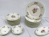 many plates and bowls that are sitting on a table