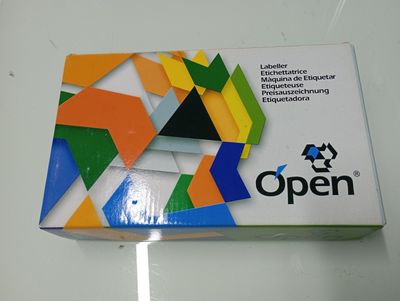 an open box of colored paper sitting on a table
