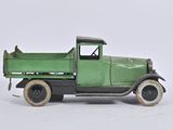 a green toy truck that is sitting on a white surface