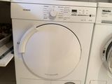 a white washer and dryer in a small room