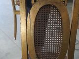 a close up of a wooden chair with a brown seat