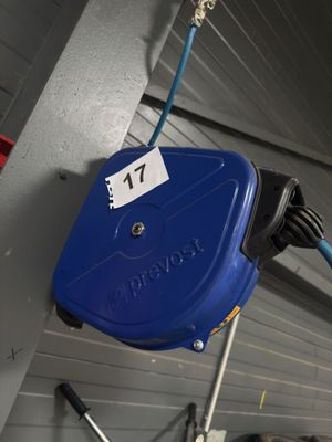 a blue hose attached to a wall with a number 77 on it