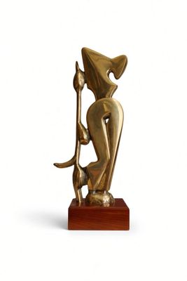 statue of a woman holding a staff on a wooden base