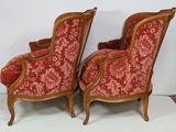 pair of red upholstered chairs with floral upholstered upholstered back