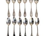 six silver spoons and two silver spoons on a white background
