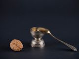 a spoon and a walnut on the table