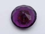 an image of a close up of a purple stone on a white surface