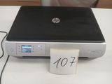 a laptop that is sitting on a table with a note attached to it