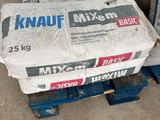 boxes of knauf mix sit on pallets in a warehouse
