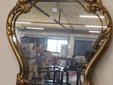 a mirror that is sitting on a table in a room