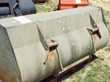 a large metal tank sitting on the ground in the grass