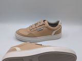 a pair of tan sneakers with white soles on a white background