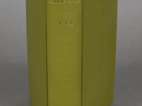 an open book with a green cover sitting on top of a table