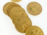 a lot of gold coins sitting on a white surface