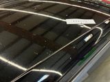 a sticker on the hood of a car in a garage