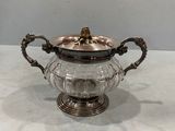 an antique silver plated teapot with a glass lid