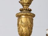 a gold colored chandelier with a bird on top of it