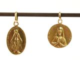 three gold medals of the virgin mary and jesus hanging on a string