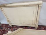 a white bed with a wooden headboard and foot board