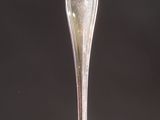 a silver spoon sitting on top of a white plate