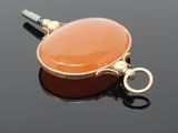 a picture of a carnel charm on a black surface