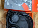 an image of a pair of headphones in a box on a wooden floor
