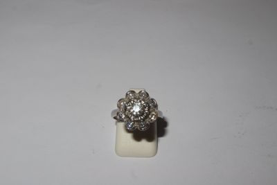 a close up of a diamond ring on a white surface